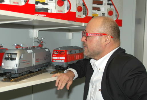 Herr Dr. René F. Wilfer vor dem Regal der Spur G Lokomotiven im Präsentationsraum im Werk Sonneberg. 